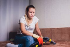 Tired woman having rest after cleaning home, lying on sofa in the living-room, copy space. Housekeeping and home stock photography Tired woman having rest after cleaning home, lying on sofa in the living-room, copy space. Housekeeping and home stock photography