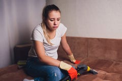 Tired woman having rest after cleaning home, lying on sofa in the living-room, copy space. Housekeeping and home royalty free stock photo Tired woman having rest after cleaning home, lying on sofa in the living-room, copy space. Housekeeping and home royalty free stock photo