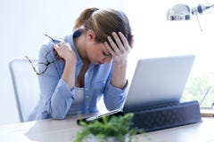 Tired Young Woman With Headache Using Her Laptop At Home. Royalty Free Stock Image