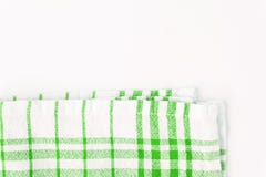 Tissu vert, une serviette de cuisine avec un modèle à carreaux, sur un petit morceau Images stock Tissu vert, une serviette de cuisine avec un modèle à carreaux, sur un petit morceau Images stock