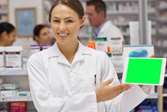 Today&#x27;s pharmacist. Portrait of an attractive pharmacist holding up a blank digital tablet display.