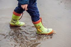 Toddler boy jumping in the puddles Royalty Free Stock Photo Toddler boy jumping in the puddles Royalty Free Stock Photo
