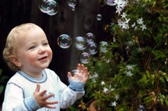 Toddler Boy Playing With Bubbles Stock Photos