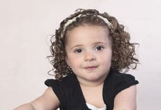 Toddler girl with curly hair and pearl headband royalty free stock images Toddler girl with curly hair and pearl headband royalty free stock images