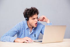 Toevallige mens in haedphones die laptop met behulp van stock afbeeldingen Toevallige mens in haedphones die laptop met behulp van stock afbeeldingen