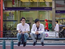 A gay couple sitting on street of Tokyo royalty free stock photo A gay couple sitting on street of Tokyo royalty free stock photo