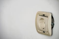 Tomada de soquete elétrica que cai fora da parede fotografia de stock Tomada de soquete elétrica que cai fora da parede fotografia de stock