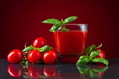 Tomato juice with tomatoes and green basil on black table stock photography Tomato juice with tomatoes and green basil on black table stock photography