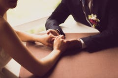 Toned photo of bride and groom holding hands at restaurant Royalty Free Stock Photos Toned photo of bride and groom holding hands at restaurant Royalty Free Stock Photos