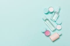 Top View Composition Of Small Travelling Bottles And Jars For Cosmetic Products On Blue Background. Facial Skin Care Concept With Royalty Free Stock Photography Top View Composition Of Small Travelling Bottles And Jars For Cosmetic Products On Blue Background. Facial Skin Care Concept With Royalty Free Stock Photography