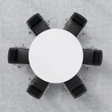 Top view of a conference room. A white round table and six chairs around. Office interior. 3D rendering.