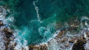 Top view of a deserted coast. Rocky shore of the island of Tenerife. Aerial drone footage of sea waves reaching shore stock video Top view of a deserted coast. Rocky shore of the island of Tenerife. Aerial drone footage of sea waves reaching shore stock video