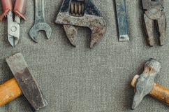 Top view different tools as hammer, screwdriver, spanner and pliers on textile background royalty free stock photography Top view different tools as hammer, screwdriver, spanner and pliers on textile background royalty free stock photography