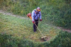 Top view fat dirty lawnmover man worker cutting dry grass with lawn mower stock images Top view fat dirty lawnmover man worker cutting dry grass with lawn mower stock images