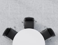 Top view of a half of the conference room. A white round table, three black leather chairs. Office interior. Stock Photos Top view of a half of the conference room. A white round table, three black leather chairs. Office interior. Stock Photos