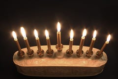Top view of a lighted Hanukkah menorah against a black background stock photo Top view of a lighted Hanukkah menorah against a black background stock photo