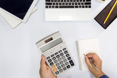 Top view. Man using calculator and writing make note. stock images Top view. Man using calculator and writing make note. stock images