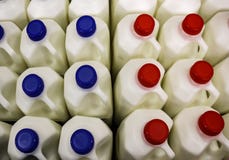 Top view of many plastic jugs of milk with red and blue caps royalty free stock image Top view of many plastic jugs of milk with red and blue caps royalty free stock image
