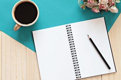 Top View Of Working Desk With Blank Notebook With Pencil, Coffee Cup And Flowers On Wooden Background Royalty Free Stock Photos Top View Of Working Desk With Blank Notebook With Pencil, Coffee Cup And Flowers On Wooden Background Royalty Free Stock Photos