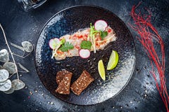 Top View On Sea Bass Ceviche Served In Dark Plate On Black Stone Background. Top View Food. Flat Lay Seafood. Fresh And Tasty Royalty Free Stock Photography