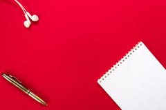 Top view open empty notebook, headphones and pen on red table background stock photos Top view open empty notebook, headphones and pen on red table background stock photos