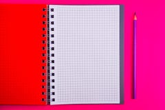Top view of open spiral blank notebook with pencil on red desk background stock image Top view of open spiral blank notebook with pencil on red desk background stock image