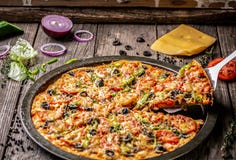 Top view of pizza with bacon and cheese with food ingredients on a wooden board. Raw vegetables on a wooden background royalty free stock photo Top view of pizza with bacon and cheese with food ingredients on a wooden board. Raw vegetables on a wooden background royalty free stock photo