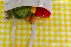 Top view of reusable shopping bag with groceries on yellow tablecloth royalty free stock photos Top view of reusable shopping bag with groceries on yellow tablecloth royalty free stock photos