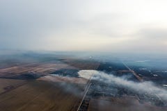 Top view of the small village. Smoke from the burning of straw i royalty free stock photos Top view of the small village. Smoke from the burning of straw i royalty free stock photos