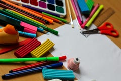 Top view on table with blank sheet of paper. Back to school concept with space for text. Color paints with paint brushes, pencils royalty free stock photo Top view on table with blank sheet of paper. Back to school concept with space for text. Color paints with paint brushes, pencils royalty free stock photo