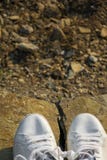 Top view of white sneakers on a mountain rock stock photography Top view of white sneakers on a mountain rock stock photography