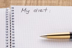 Top view workplace notebook and pen on wood table background, retro effect. Inscription - My diet stock photo Top view workplace notebook and pen on wood table background, retro effect. Inscription - My diet stock photo