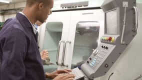 Torno automatizado uso de Teaching Apprentice To del ingeniero almacen de metraje de vídeo Torno automatizado uso de Teaching Apprentice To del ingeniero almacen de metraje de vídeo