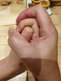 A touching moment that holding hand of a father to his daughter stock images A touching moment that holding hand of a father to his daughter stock images