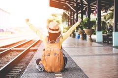Tourist asian lifestyle women wearing backpack holding map, traveler siting for waiting a train, so happy and relax stock image Tourist asian lifestyle women wearing backpack holding map, traveler siting for waiting a train, so happy and relax stock image