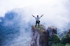 Tourist explorer man at top of mountain cloud background stock images Tourist explorer man at top of mountain cloud background stock images