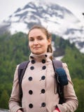 Tourist girl with a backpack on the backdrop of snow-capped mountains stock photos Tourist girl with a backpack on the backdrop of snow-capped mountains stock photos