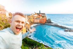 Tourist happy young man taking selfie photo Vernazza, national park Cinque Terre, Liguria, Italy, Europe. Concept travel royalty free stock photography Tourist happy young man taking selfie photo Vernazza, national park Cinque Terre, Liguria, Italy, Europe. Concept travel royalty free stock photography