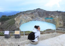 Tourist on Kelimutu watching unique lakes Tap and Tin royalty free stock photography Tourist on Kelimutu watching unique lakes Tap and Tin royalty free stock photography