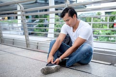 tourist man sitting on floor take off the shoes massaging feet walking a lot of foot pain after a long walk royalty free stock photography tourist man sitting on floor take off the shoes massaging feet walking a lot of foot pain after a long walk royalty free stock photography