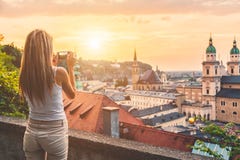 Tourist taking a photo of beatiful sunset in Salzburg Austria Stock Image Tourist taking a photo of beatiful sunset in Salzburg Austria Stock Image