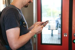 A tourist on the train uses a mobile phone. stock photo A tourist on the train uses a mobile phone. stock photo