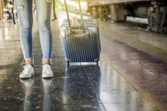 A tourist walks a luggage at the train station. Waiting for the train, Self-guided travel concept, Summer vacation in Asia stock photos A tourist walks a luggage at the train station. Waiting for the train, Self-guided travel concept, Summer vacation in Asia stock photos