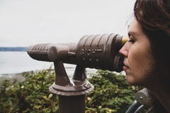 Tourist woman looking through scope at ocean view point stock images Tourist woman looking through scope at ocean view point stock images