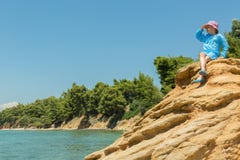 Tourist young girl on Aegean coast of Sithonia peninsula Royalty Free Stock Photography Tourist young girl on Aegean coast of Sithonia peninsula Royalty Free Stock Photography
