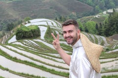 Touriste caucasien beau dans les terrasses asiatiques de riz photographie stock Touriste caucasien beau dans les terrasses asiatiques de riz photographie stock