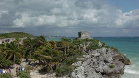 Tourists are walking in archaelogical ruins of Tulum stock images Tourists are walking in archaelogical ruins of Tulum stock images