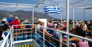 Tourists sailing on the open deck on the ship for a tour to the Bay of Balos royalty free stock photography Tourists sailing on the open deck on the ship for a tour to the Bay of Balos royalty free stock photography