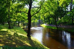 Tourists walk in the city park in the summer in Riga Royalty Free Stock Photo Tourists walk in the city park in the summer in Riga Royalty Free Stock Photo