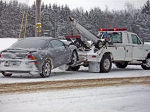 wrecker towing a car in winter
